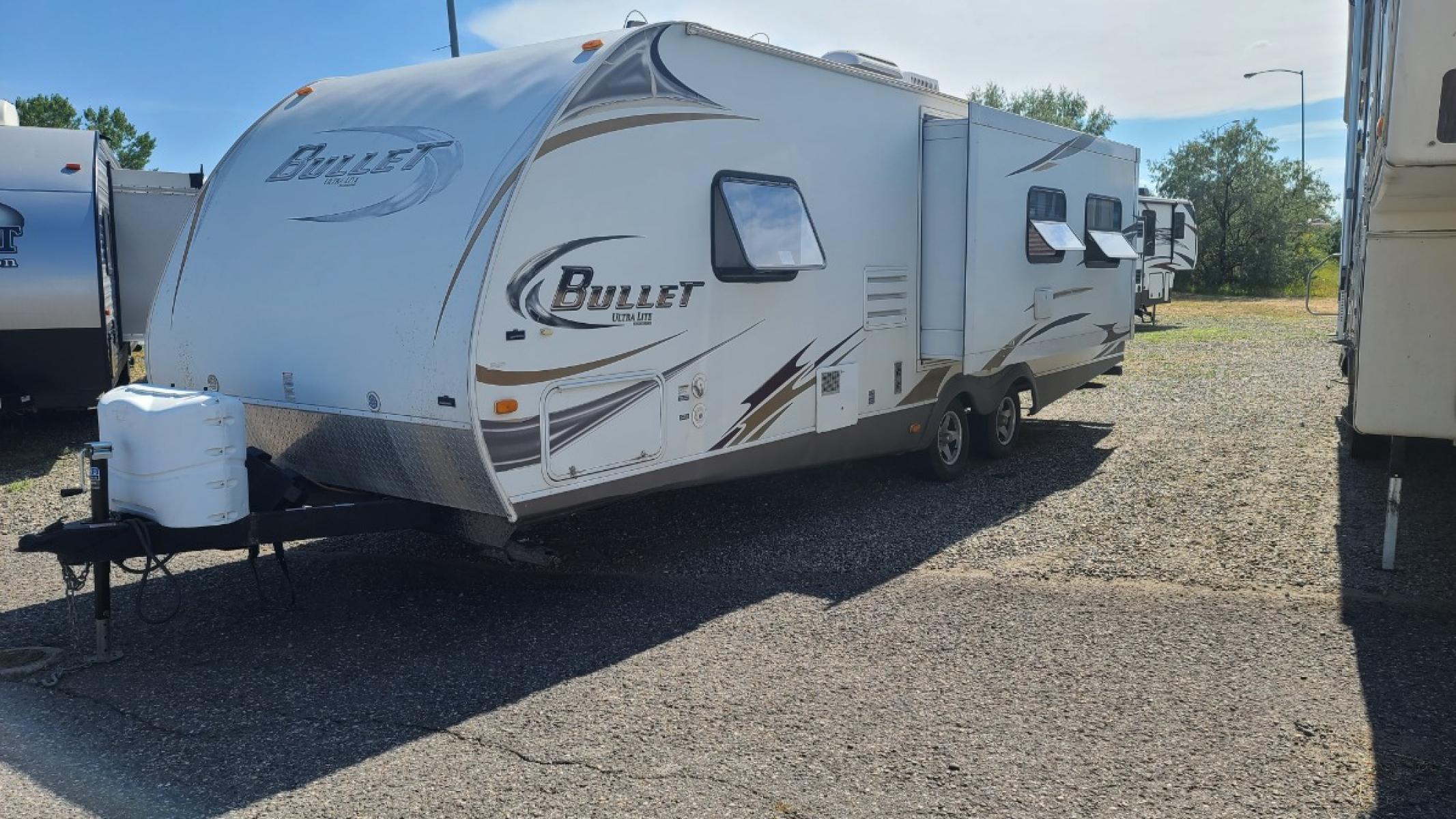 2011 White Keystone Bullrt , located at 923 US HWY 87 E., Billings, MT, 59101, (406) 245-0456, 45.795788, -108.451881 - 2011 Keystone Bullet ultralight, model 278RLS, 27 ft with one super slide, rear living room, two rear rockers, heated enclosed underbelly, front Queen walk around bed, u shaped dinette and jackknife couch both make into beds, could sleep eight, a/c, hot water, furnace, dry weight 4986 lb. John at 40 - Photo #0
