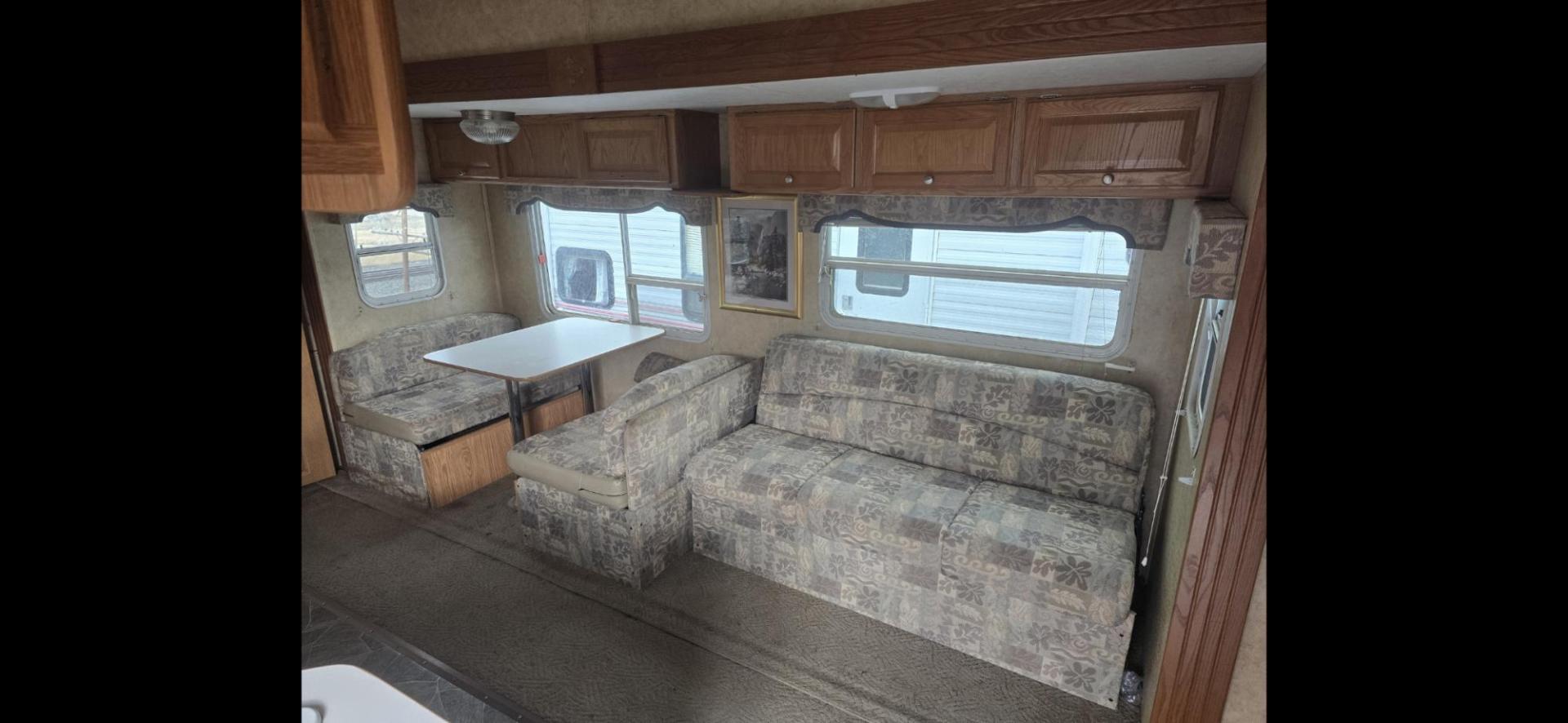 2006 White Pilgrim 5th wheel , located at 923 US HWY 87 E., Billings, MT, 59101, (406) 245-0456, 45.795788, -108.451881 - This is a very nice 1/2 ton towable 27' fifth wheel with a full super slide. Front queen walk around bed and rear double bunks. Couch and booth dynette both make into beds, could sleep 8. flipped axles for clearance, a/c, forced air heat, hot water, inside/outside showers, full bath shower toilet a - Photo#5