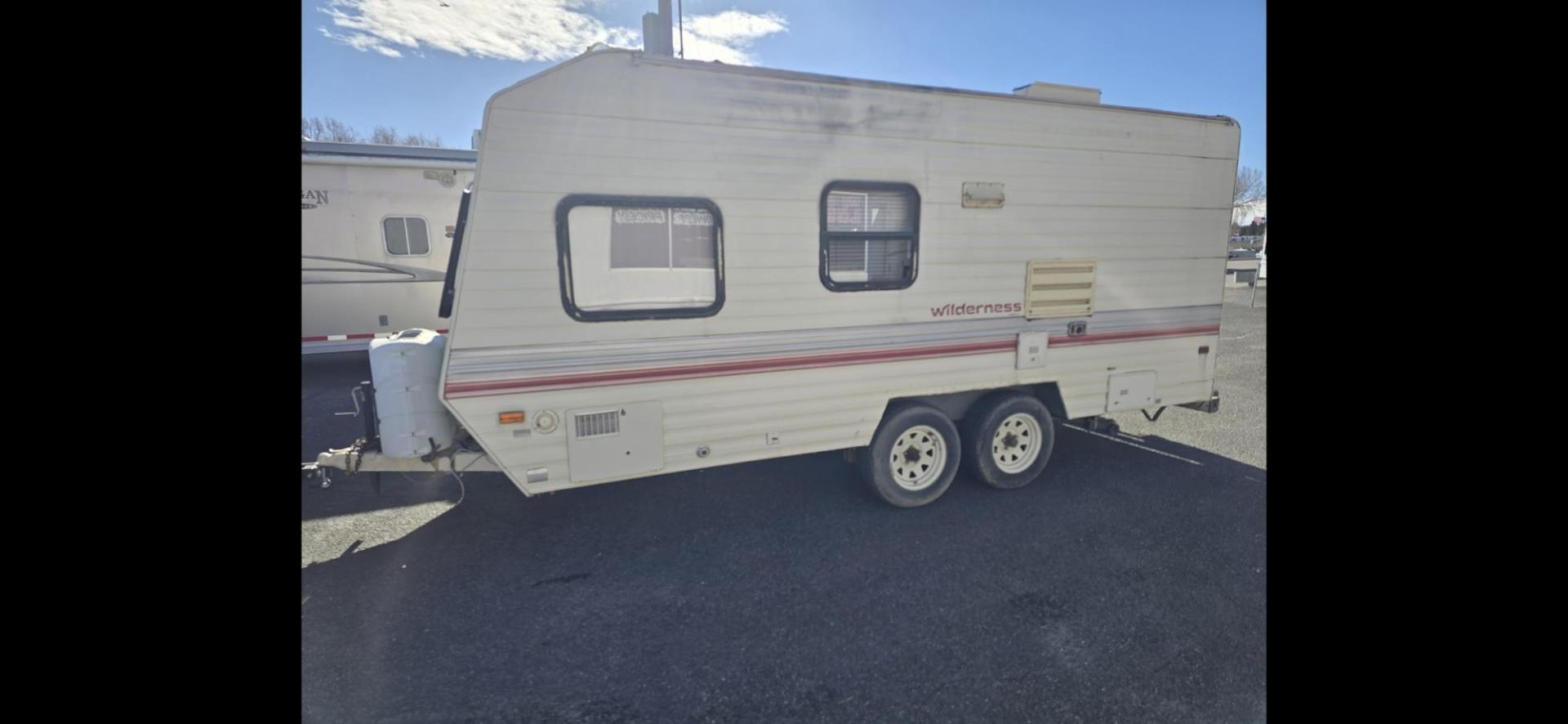 1993 White Fleetwood Wilderness , located at 923 US HWY 87 E., Billings, MT, 59101, (406) 245-0456, 45.795788, -108.451881 - 1993 Fleetwood Wilderness CAMPING ON A BUDGET!!! 19' travel trailer that is 1/2 ton towable. Booth dinette and Jack knife couch both make into beds. Full bath, shower toilet, AC, furnace. Nice sized refrigerator, front viewing window, 6 gal hot water heater. WE CERTIFY OUR USED TRAILERS!!! John - Photo#0