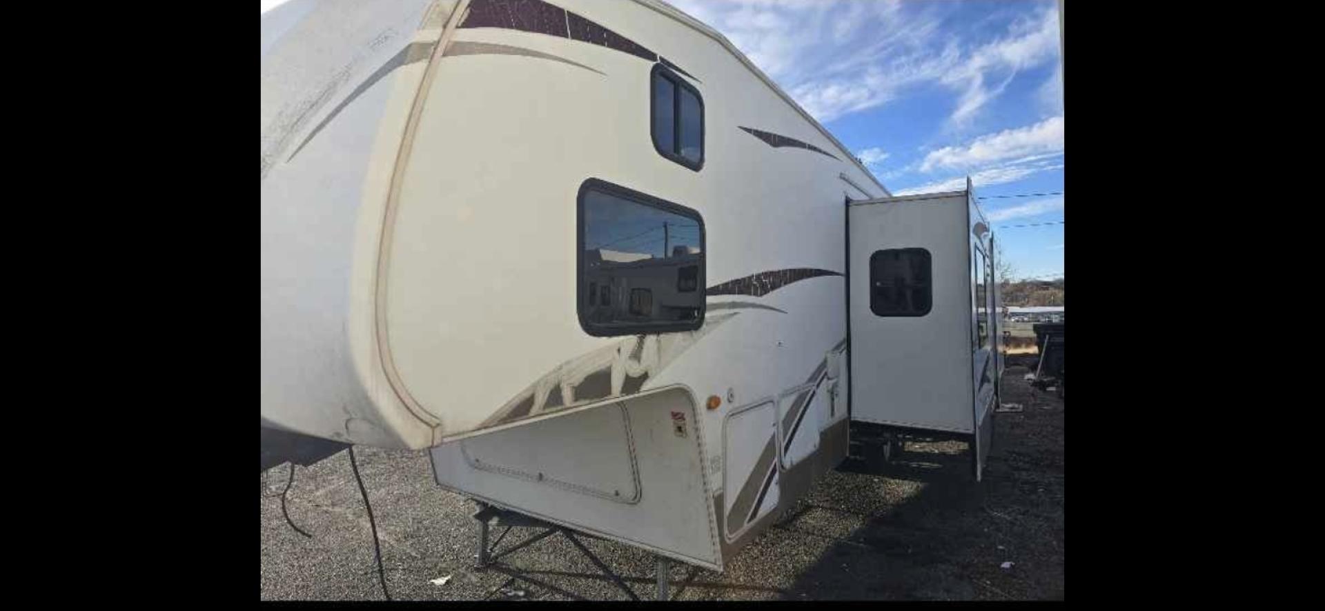 2009 White Keystone Laredo , located at 923 US HWY 87 E., Billings, MT, 59101, (406) 245-0456, 45.795788, -108.451881 - 2009 Keystone Laredo 32RS LOCATED IN BILLINGS MT $11,900 Very nice fifth wheel with two slides and front triple bunks. Rear suite with queen bed. Couch makes into bed. Stand alone kitchen table and chairs. Could sleep 7. Auto awnings and auto front jacks, solid corrian countertops, oak cabinets - Photo#0