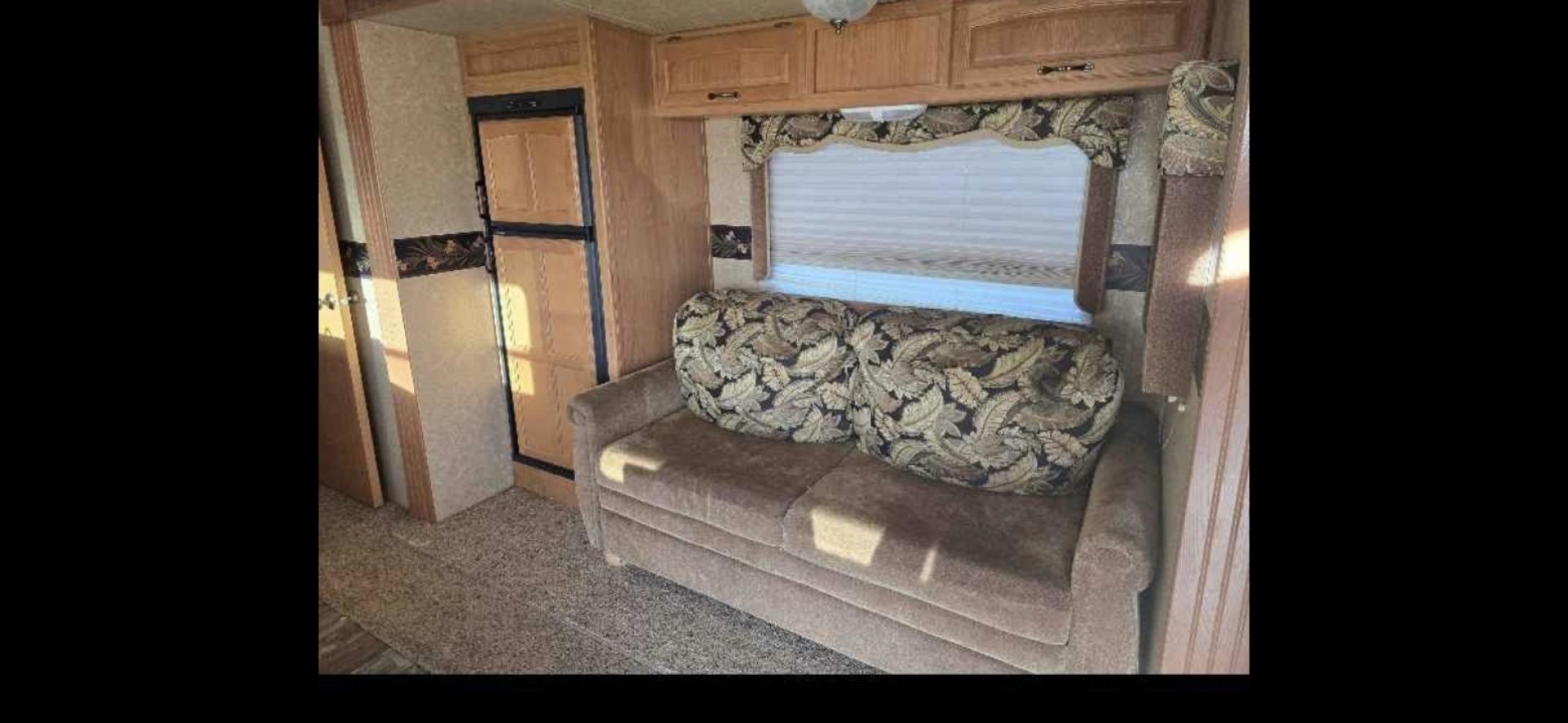 2009 White Keystone Laredo , located at 923 US HWY 87 E., Billings, MT, 59101, (406) 245-0456, 45.795788, -108.451881 - 2009 Keystone Laredo 32RS LOCATED IN BILLINGS MT $11,900 Very nice fifth wheel with two slides and front triple bunks. Rear suite with queen bed. Couch makes into bed. Stand alone kitchen table and chairs. Could sleep 7. Auto awnings and auto front jacks, solid corrian countertops, oak cabinets - Photo#6